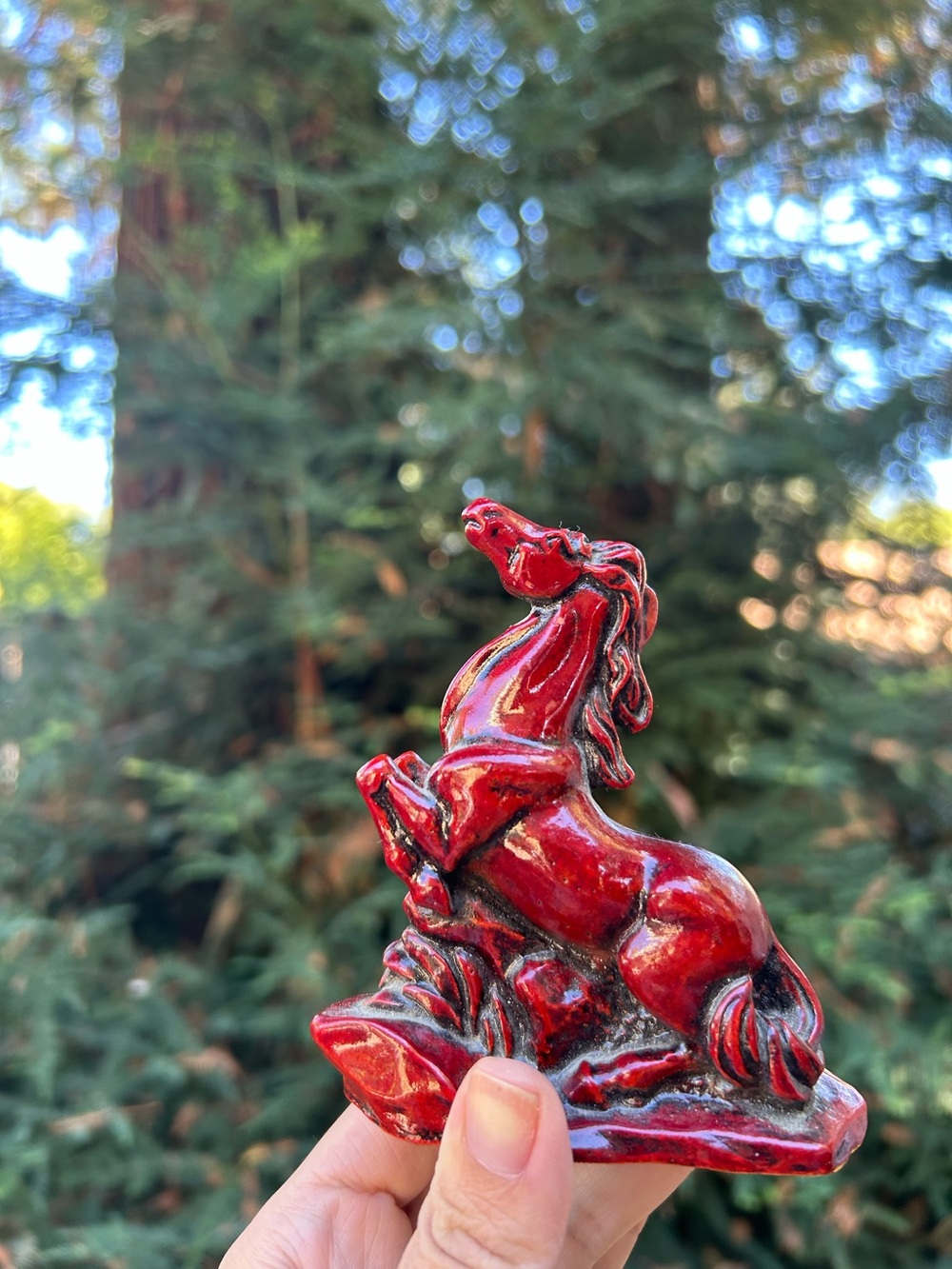 vintage Chinese red resin or faux-cinnabar horse figurine, often styled for Feng